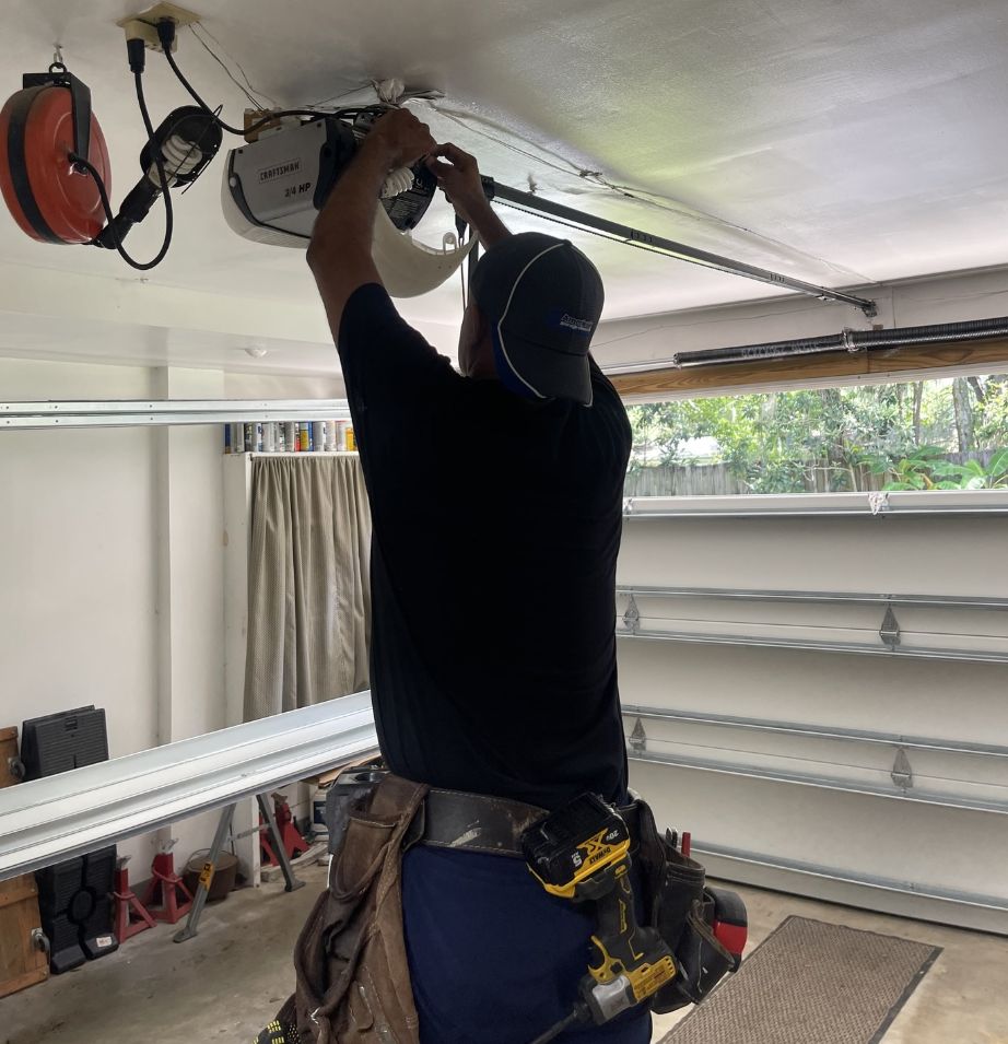 Professional garage door repair technician working on opener in Atlantic Beach